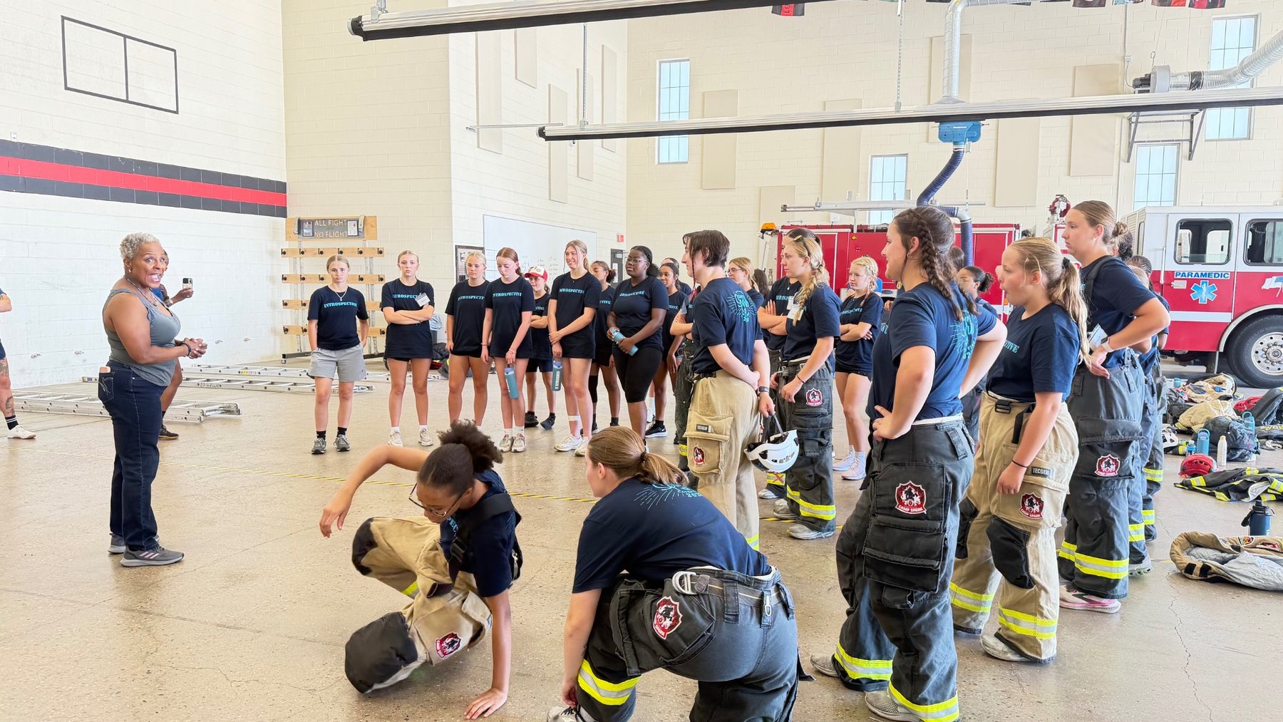 Stephanie Hancock speaks with Camp Spark participants inside an Aurora Fire Rescue training facility